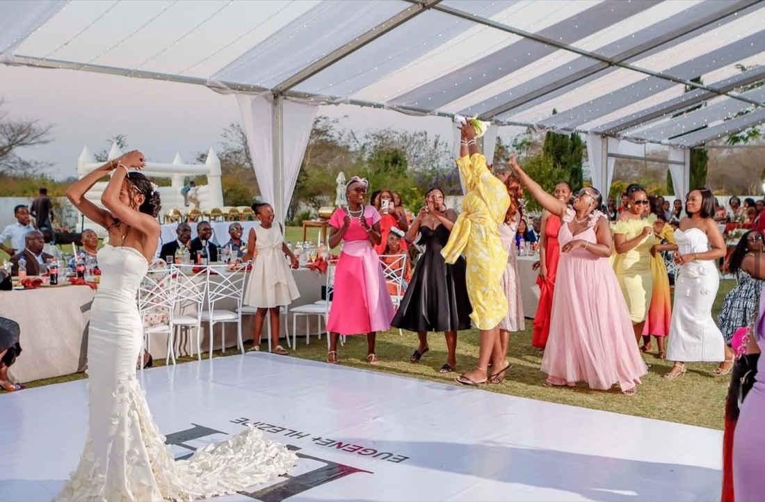 Bouquet toss at a garden reception